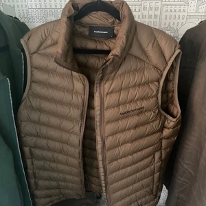 Peak Performance Dunväst - Snygg Peak Performance väst i beige, perfekt till våren. Endast använd en gång och säljer den pga att den inte passar mig. Om det är några frågor är det bara att höra av sig!