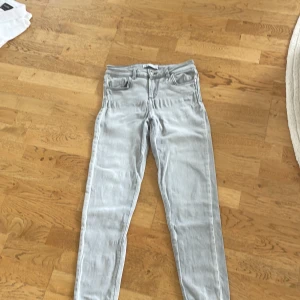 Ljusgrå skinny jeans från Zara - Snygga ljusgrå skinny jeans från Zara i storlek 36. Klassisk femficksmodell med bälteshällor och dragkedjegylf. Jeansen har en tight passform och är tillverkade i mjuk bomullsdenim med lite stretch för extra komfort.