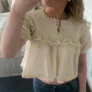 Krämvit blus med volang och spets🥰 - Jag säljer min extremt söta blus från Zara! Jag har bara använt den några få gånger, och den har varit bra omhändertagen! Varför jag säljer den är för att jag inte andvänder den längre.❤️