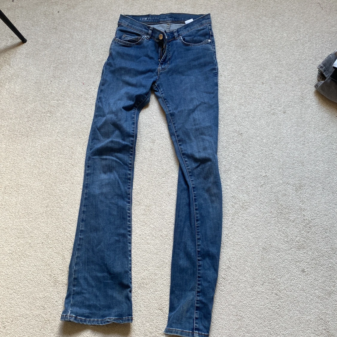 Blå low flare jeans med slitna benslut