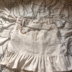 Vit kortkjol med volang och bälte - Supersöt vit kortkjol. Använd en gång .