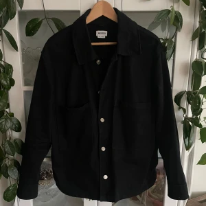 Svart overshirt från Weekday - Säljer min overshitt/jacka från weekday. Den är i väldigt bra skick och har inte använts ofta dock lite använd runt knapparna. Jag diskuterar gärna pris och om du har några frågor eller vill ha fler bilder så är det bara att skriva till mig :)