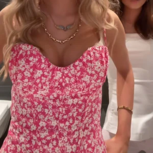 Rosa blommig korsettbody - Säljer en söt rosa korsettbody med vita blommor. Bodyn har smala axelband och en figurnära passform som framhäver midjan. Perfekt för sommarens alla tillfällen! 🌸Den virala bodyn från Zara🩷🩷Om ni vill ha egna bilder eller andra frågor är det bara att höra av sig!!