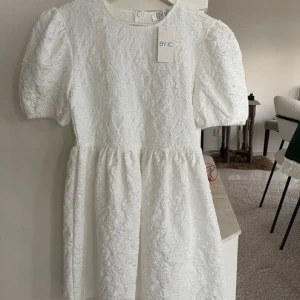 Vit klänning från BYIC - Säljer den gulliga BYIC klänningen som är helt slutsåld på nätet. Nyskick då det finns prislapp kvar och den aldrig varit använd. Passar även s! 