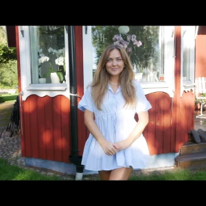 Ljusblå kortklänning med knyt i midjan - Söt ljusblå klänning med kort ärm och knappar framtill. Klänningen har en avslappnad passform, markerad midja med knytband och en lätt utställd kjol. Perfekt för varma dagar och har en fräsch, somrig känsla 🩵🩵🩵