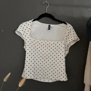 Vit prickig topp  - Säljer denna söta topp med fyrkantig urringning! Använd en gång! Strlk M men passar bra på mindre då den är lite tajt