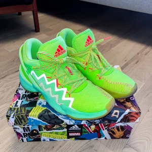 Adidan Don Issue #2 Stl. 41 - Snygga gröna Adidas D.O.N. Issue #2 Spider-Man Edition med stiliserade Marvel/Spider-Man-detaljer, inklusive Spider-Man-huvudet på den inre tungan. Skorna har använts endast ett par enstaka gånger, då basket visade sig inte vara sporten för mig. Hoppas på att de kommer till bättre användning hoss någon annan. Originalkartong och skyddspapper ingår självklart.  Nypris ligger runt 1400 kr – mitt pris är 700kr.  Finns för hämtning i Jönköping. Huskvarna eller kan skickas mot fraktkostnad.