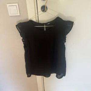 Svart blus med volangärmar från Only - Säljer en svart blus från Only med fina volangdetaljer på ärmarna.🩷