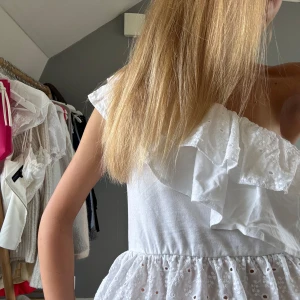 Vit omlott topp med volang och spets! - Säljer mina jättefina och söta off shoulder topp🥰 Toppen är helt ny och aldrig använd, hör av er vid frågor💞