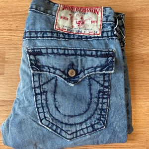 True Religion Jeans Ricky Super T  - Feta true religion jeans, straight, storlek 33, mycket bra skick, små slitningar, 45cm midja, 109cm längd, 83.5cm innerben, 24cm ben öppning.  