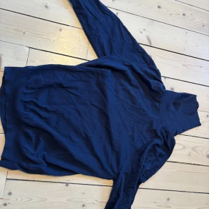 Mörkblå polotröja från GANT - Snygg mörkblå polotröja från GANT i mjuk bomull. Tröjan har lång ärm och klassisk polokrage som ger en clean och stilren look. Diskret GANT-logga broderad på bröstet. Perfekt för dig som gillar enkel och tidlös stil.