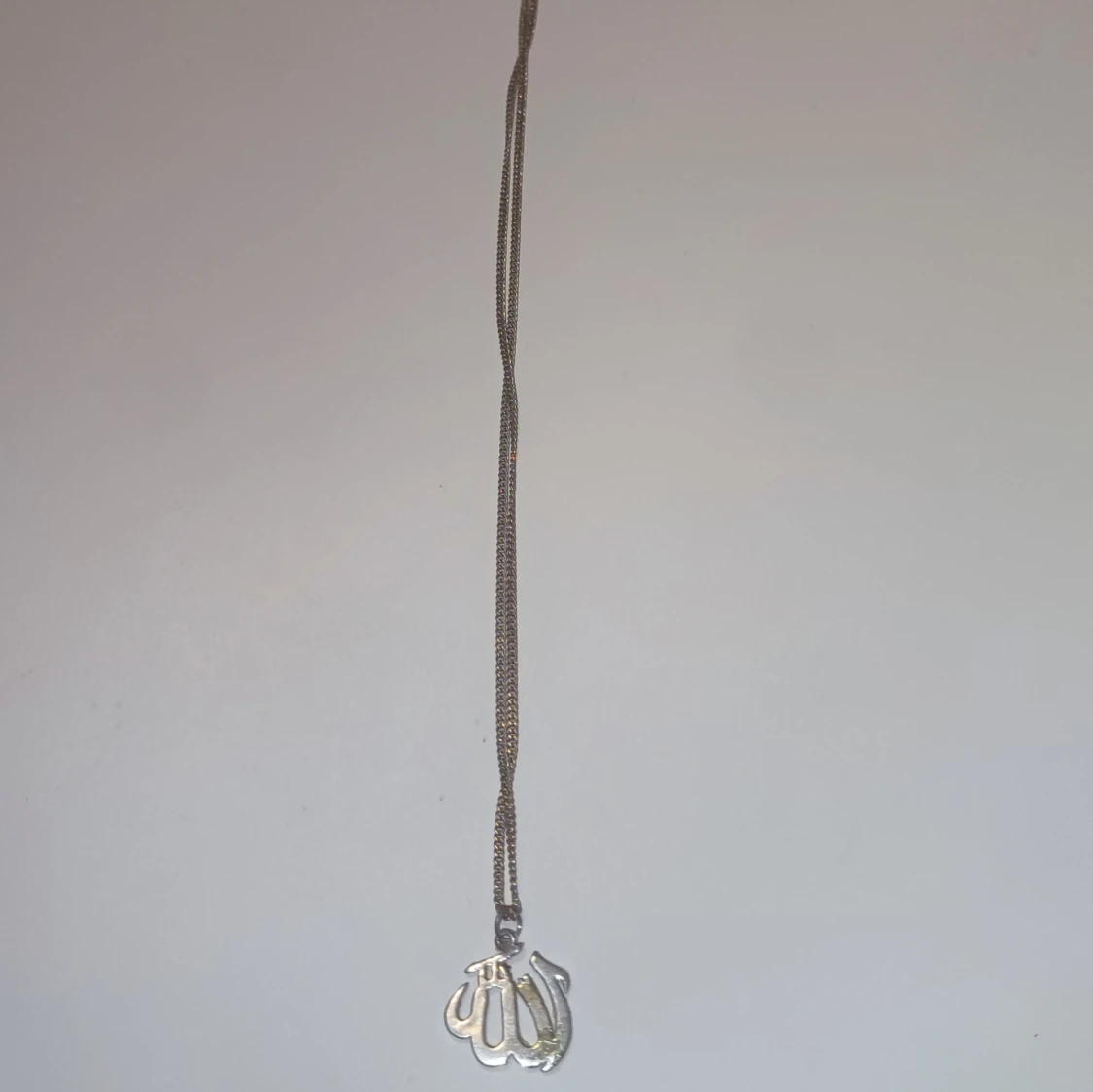 Silverfärgat halsband med arabisk berlock