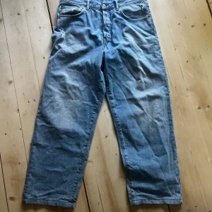 Blå Acne Studios jeans - Säljer ett par klassiska blå jeans från Acne Studios i rak modell. Jeansen har fem fickor, gylf med dragkedja och knapp samt normal passform. Perfekta till vardags och enkla att matcha med olika stilar. Storlek 31/34 men har kortats ner, bara lite så passar fortf den storlek.