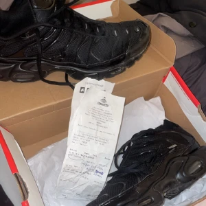 Nike Air Max Plus TN helsvarta sneakers - Säljer ett par helsvarta Nike Air Max Plus TN Sulan på ena skon är lite av men borde gå att superlimma har använt 1 månad ungefär kommer med kvitto lite av vågarna har trillat av på den ena skicka Pm för fler bilder! Size 10.5 Eur 44.5 Säljer pga passar inte bra med min sorts byxor 