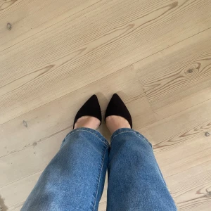 Pumps klackar - Säljer ett par eleganta svarta pumps. Skorna har spetsig tå, hög klack och är tillverkade i mocka. Perfekta för dig som vill ha en stilren och klassisk look.