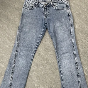 Ljusblå jeans med broderade bakfickor - Snygga ljusblå jeans från ginatricot med unika broderade detaljer på bakfickorna. Storlek 36 Klassisk femficksmodell i tvättad denim och lågmidja jeans. Perfekta att ha på sig när man vill.
