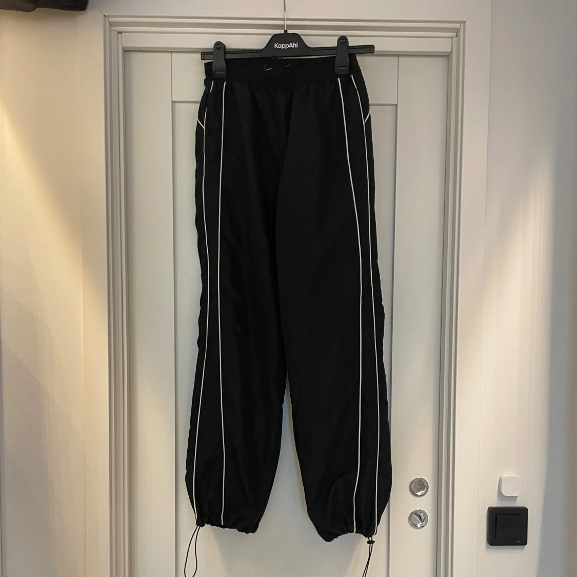 Svarta mjukisbyxor i glansigt material med vita detaljer - 3