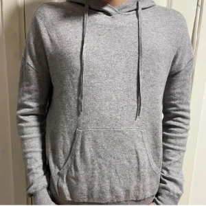 Grå hoodie från J.Lindeberg - Säljer min fina kashmir tröja från J.Lindberg. Den är grå men svart på sidan. Storlek xs använd ett fåtal gånger. Hör av er vid frågor:)