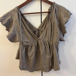 Beige omlott blus med volang -  beige blus, liten i storleken 