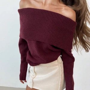 Vinröd offshoulder tröja - Säljer en superfin vinröd  tröja som är perfekt för höst och vinter. Den är stickad och har långa ärmar, vilket gör den både stilren och mysig. Passar perfekt till både jeans och kjol!