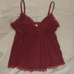Vinrött sött linne från Nelly - Säljer ett superfint vinrött linne från Nelly i storlek XS. Linnet har söta spetsdetaljer. Hör av dig vid minsta fundering!