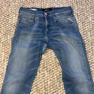 Replay Anbass jeans - Ljusblåa replay anbass jeans! Som ni ser på bild fyra är det lite slitage mellan benen på jeansen men annars är dem i toppen skick!  W29 L30 