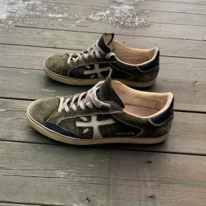 Gröna sneakers från Premiata - Snygga gröna sneakers från Premiata med vita detaljer och snörning. Byter helst mot rockrunners men kan sälja! Pris: 1949 för mockan är rätt sliten tyvärr (inte hugget i sten), Box finns! Skriv pm vid frågor, skickar inom 24 timmar📩