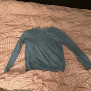 J Lindberg V neck - En blå J Lindberg V neck som passar perfekt till sommaren om man lirar golf. Är storlek L men liten i storleken. Passar dig som är runt 180. Nypris ligger på 850kr, men med tanke på att den är använd släpper jag den för 350kr. Hör gärna av dig vid fler frågor // Simon