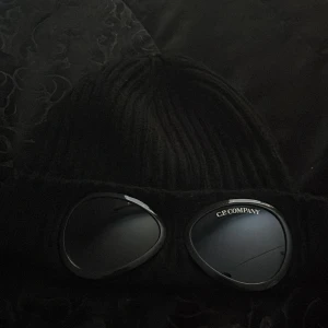Cp Company mössa - Säljer nu min mössa som jag har använt till skidor/ vanligt bruk. Jag har tagit hand om den väl och skicket är 10/10  Obs.. Man kan använda glasögonen och dem är perfekt om du åker skidor eller bara vill ha på dig dem.   Priset är ej hugget på sten! 