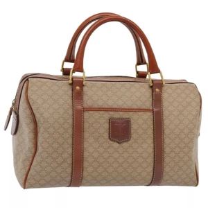 Celine Macadam Boston väska - Celine Macadam Boston-väskan är en tidlös pjäs som visar upp det franska lyxmärkets ikoniska elegans. Väskan har den berömda monogramduken, omsorgsfullt tillverkad av slitstark belagd duk och accentuerad med hårdvara av naturlig kohud.