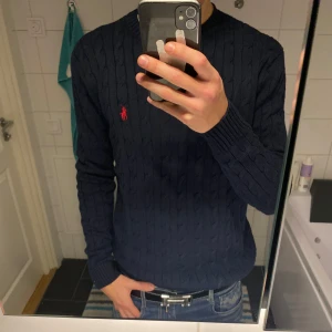 Stickad polo tröja - Säljer denna snygga mörkblå Polo Ralph Lauren crewneck i storlek S då jag växt ur den. Den är i 10/10 skick och knappt använd. Skicka ett meddelande vid frågor eller funderingar!😁