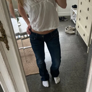 Mörkblå jeans från Guess - Säljer ett par supersnygga mörkblå jeans som är både utsvängda och lågmidjade från Guess i storlek 31. De är i mycket bra skick och har använts ett fåtal gånger. Innerlårbenet är ca 106 cm, de är därmed lite långa för mig som är 160 cm. Skulle rekommendera till folk som är från ca 165-175cm. Passformen är XS/S💞💗