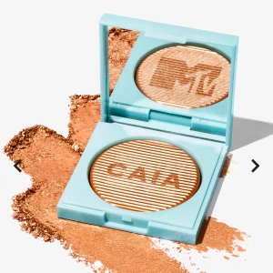 Bronzer från CAIA x MTV - Upptäck en bronzer från CAIA i samarbete med MTV. Den kommer i en turkos förpackning med spegel och har en varm, skimrande nyans. Perfekt för att ge ansiktet en solkysst look. En body-highlighter med en flirtig doft som passar alla festliga tillfällen! Pudret smälter in i huden och ger en silkeslen känsla och lyster tack vare formulans glänsande pärlpigment. Helt ny 