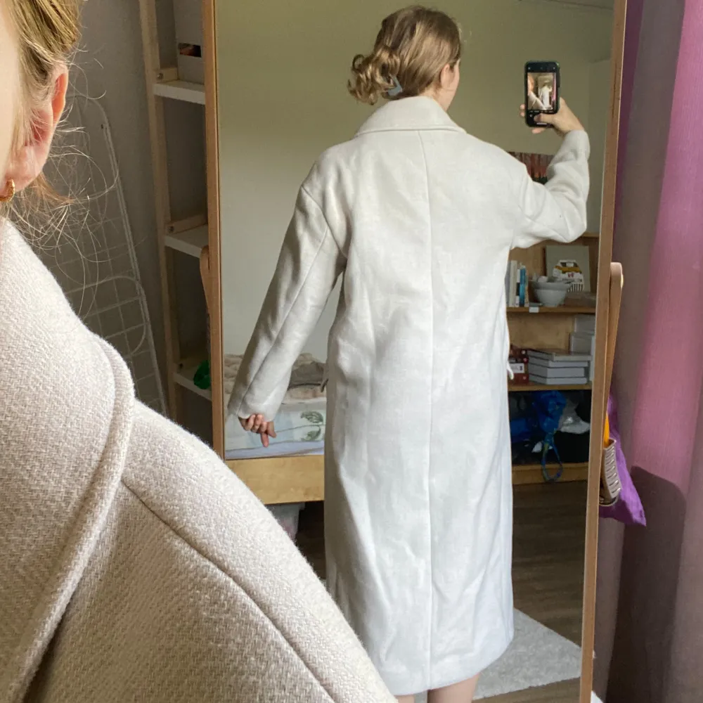 Beige kappa från H&M. De två sista bilderna visar färgen bäst. Fint skick. Lite nopprig på vissa ställen, men jag har använt noppborttagare så det är knappt märkbart. Den har ett märke (bild 4), men det döljs om man stänger kappan & är ganska diskret. Takit.