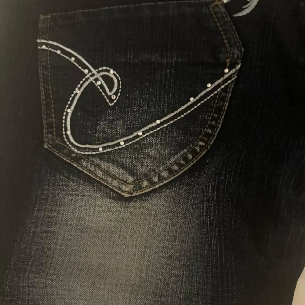 Super snygga lågmidjade ”y2k” jeans med coola broderade detaljer på bakfickorna.  Knappt använda!. Jeans & Byxor.