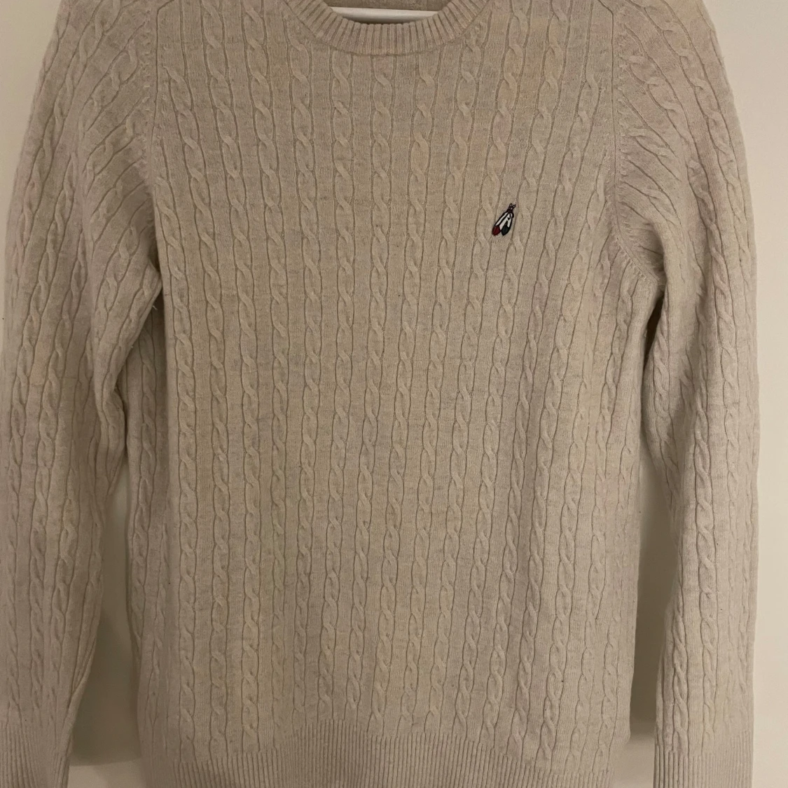 Beige stickad tröja från Peak Performance