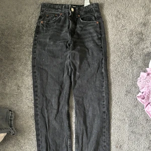 Svarta jeans - Säljer ett par snygga svarta jeans i mycket bra skick. De är mellanmidjade och sitter snyggt på. Knappt använda. Kontakta för mer💗