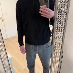 Svart tröja med dragkedja - Säljer en stilren svart tröja med dragkedja i kragen. Perfekt för både vardag och lite finare tillfällen. Tröjan har långa ärmar och en normal passform. Den är superbekväm och lätt att matcha med olika outfits. Passar perfekt till höst och vår!