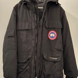 Svart parkajacka från Canada Goose - Säljer en svart parkajacka från Canada Goose i bra skick. Köpte den här, men var för stor i storleken. Ny dragkedja och precis kemtvättas.