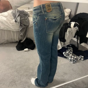 Blå lågmidjade jeans - Snygga blåa lågmidjade jeans med en klassisk bootcut-stil. De har en låg midja och är tillverkade i ett slitstarkt denimtyg. Perfekta för en avslappnad look. Storleken är Size 28 Length 36. Säljer då dom inte passar mig
