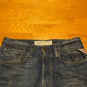 Blå jeans från Replay - Snygga blå jeans från Replay med klassisk femficksdesign och knappgylf. Perfekta för en avslappnad stil. Byter och samfraktar