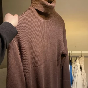 Brun stivkad klänning med slits!  - Brun stickad klänning från Bikbok i storlek XS! Långklänning som sträcker sug till knäna! Helt oanvänd klänning som passar perfekt till hösten och till och med våren!   Klänningen har en polokrage och vida armar! Det finns även en slits vid ena sidan