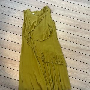 Oscar de la renta- vintage klänning - Fin vintage från oscar de la renta. I bra skick! Längd 94 cm färgen är gul/grön. Fina volanger-figursydd. Två lager tyg som faller vackert. 