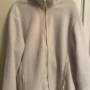 Vit fleecejacka från McKinley - Vit fleecejacka från McKinley i storlek L. Den är i väldigt bra skick då den legat i garderoben länge och aldrig blivit använd så säljer den för tror inte jag kommer använda den framöver.