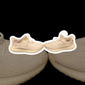 Yeezy Boost 350 V2 Cream White (EU 41 1/3) - •	Nuvarande pris: 1000 kr 🏷️ 	•	Originalpris: 2500 kr 💎 	•	Beskrivning: Minimalistiska sneakers från Kanye Wests Yeezy-kollektion, kända för sin bekväma Boost-sula och tidlösa design.