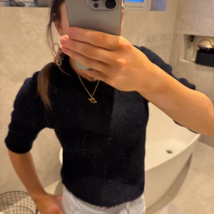 Svart tröja från InWear - Säljer en stilren svart tröja från InWear. Tröjan har en klassisk design med trekvartsärmar och är tillverkad i ett mjukt ull material. Perfekt för en elegant och avslappnad look.