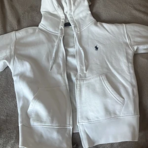 Vit zip up från Ralph Lauren - Säljer en superfin vit zip hoodie med mörkblå Ralph Lauren märke. Nypris 2200. Säljer den då den inte kommer till användning ❤️ Skriv om ni har några frågor! 