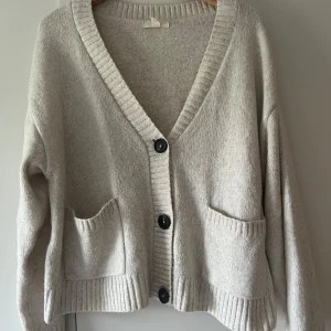 Stickad kofta - Beige stickad kofta från HM som inte kommer till användning längre. Supermysig nu till hösten och sparsamt använd! Kan mötas upp i Örebro eller skickas mot frakt.