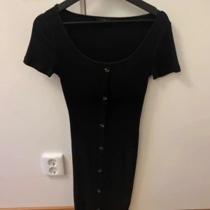 Svart klänning  - Säljer denna svarta klänningen emd knappar ifrån New yorker. Knappt använd och inga defekter💓