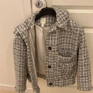 Rutig kavaj i tweed - Säljer en superfin rutig kavaj i tweed med fransiga kanter. Den har en klassisk krage och knappar framtill. Perfekt för höst och vår, och funkar både till vardags och fest. Storlek är dam S. Passar perfekt till jeans eller en kjol för en chic look!